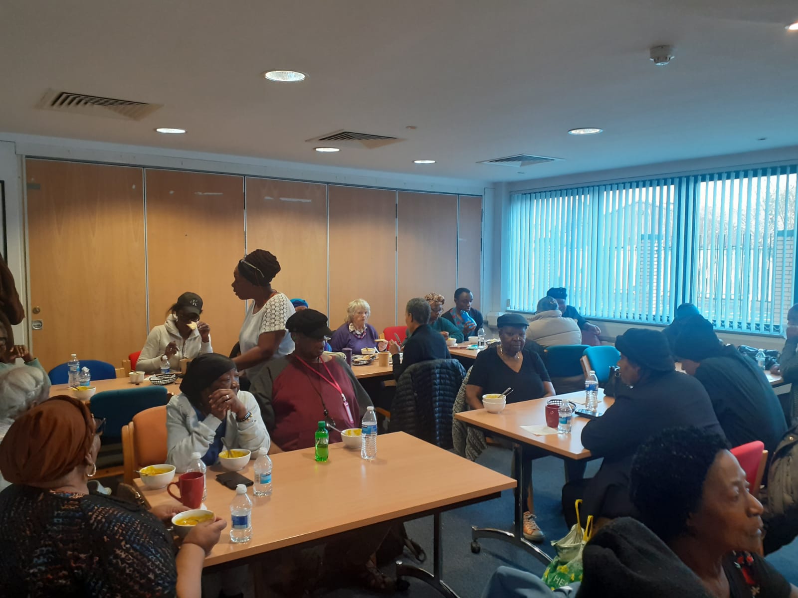 Dining room with community members sharing a meal