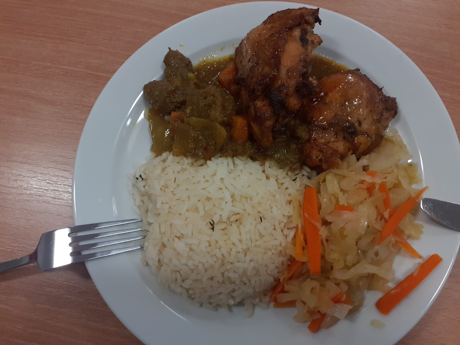 Complete meal with chicken, rice, curry, and coleslaw