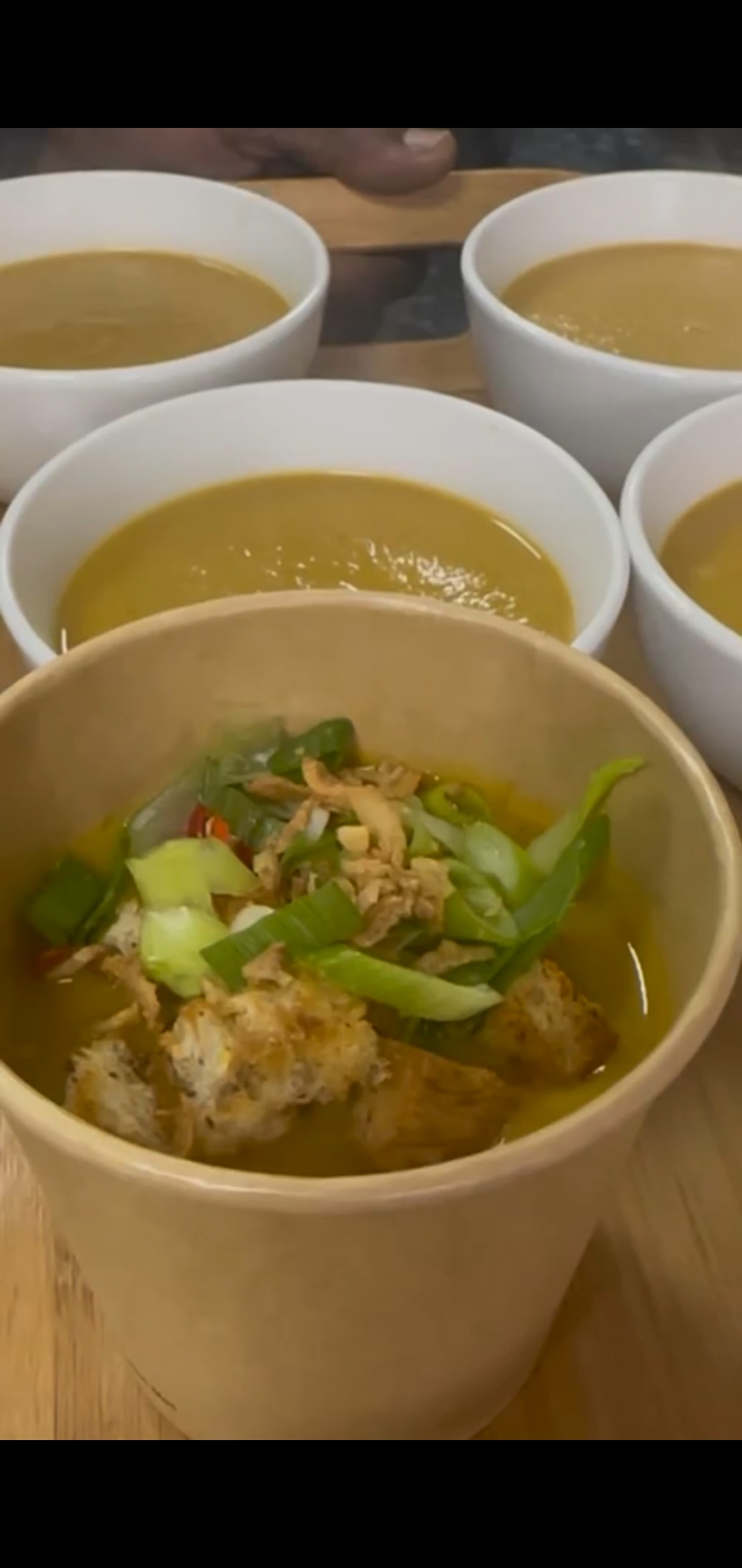 Warm homemade soup with garnishes